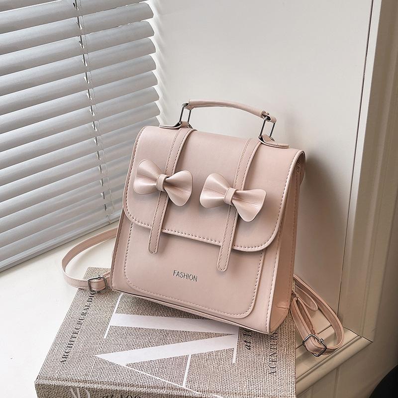 South Korea solid color college style commuter backpack women 2025 new trend bow portable shoulder messenger bag