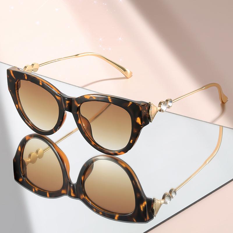 New cat-eye sunglasses with diamond-like embellishments on metal temples for a high-end versatile look