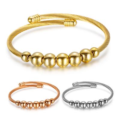 Bracciale elastico simmetrico aperto scorrevole con perline tonde in filo d'acciaio. Bracciale elastico tricolore