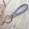 Gevlochten Lederen Touw Sleutelhanger met Poppenhanger - Modieus en Creatief Accessoire