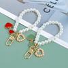 2Pcs Anti-Loss Pearl Chain Wristband Keychain  Peach Heart Pendant Key Ring For Women Phone Handbag Ornament Party Gifts