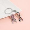 Creative and unique pink ribbon brooch keychain alloy drip pendant D1282