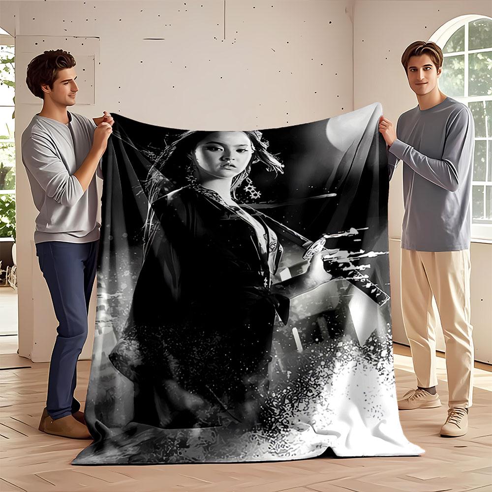 A woman holding a sword in a dynamic, monochromatic composition. for all seasons blanket lunch break throw gift