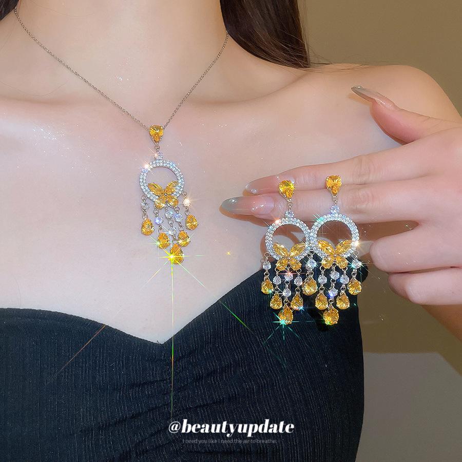 Silver Needle Diamond Inlaid Butterfly Tassel Earrings and Necklace Set: Elegant Hollow Design with Personality and Style.