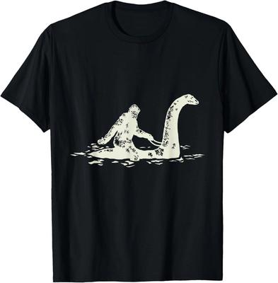 Bigfoot Sasquatch Cavalca il Mostro di Loch Ness Divertente, Maglietta a Maniche Corte