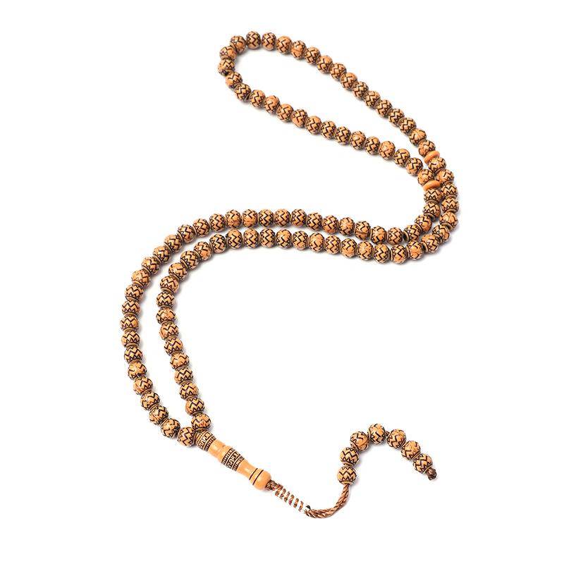 Ručně vyráběný 99-korálkový růženec Tasbih s imitací dřevěné kresby ze Saúdské Arábie
