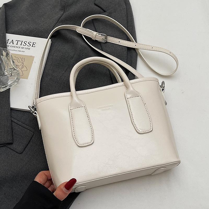 New High-end Korean Version Hugh Simple Portable Bucket Bag Versatile Commuter Fashion Niche Messenger Bag Bag Woman