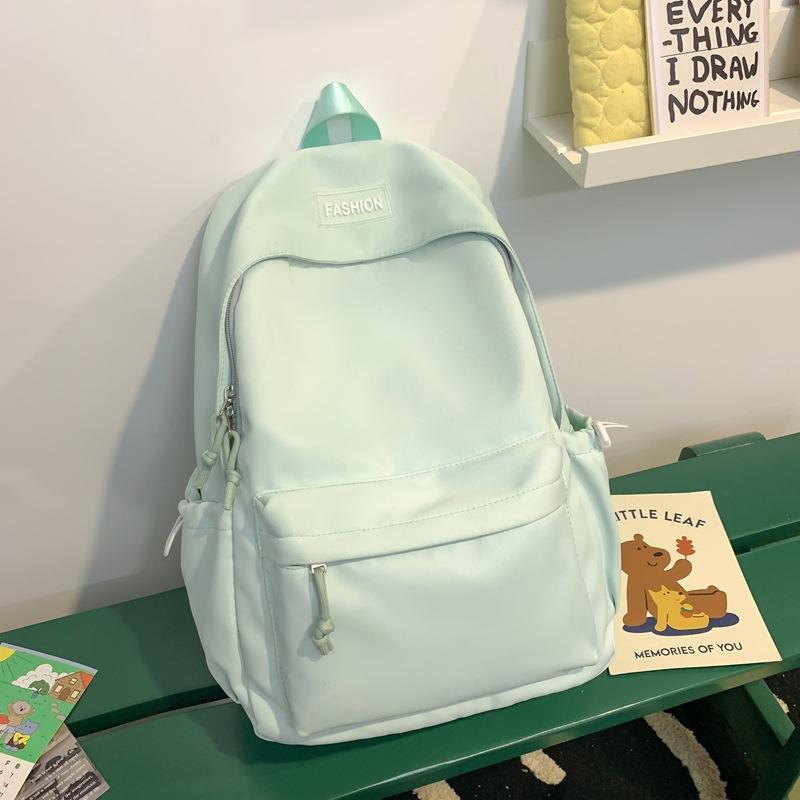 The schoolbag is fresh and sweet, and the solid color is versatile and simple. The schoolbag for junior high school students is light