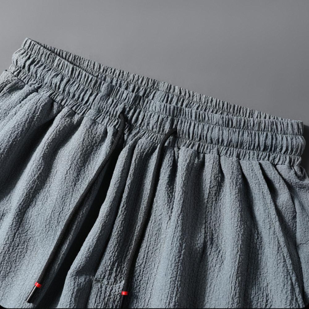 Męskie spodnie casualowe ze ściągaczem w pasie i modnym wzorem Harlan Pants Sportowe luźne spodnie w jednolitym kolorze