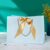 In-Stock White Cardboard Gift Bags with Bow Handle, Customizable Logo for Clothing Stores