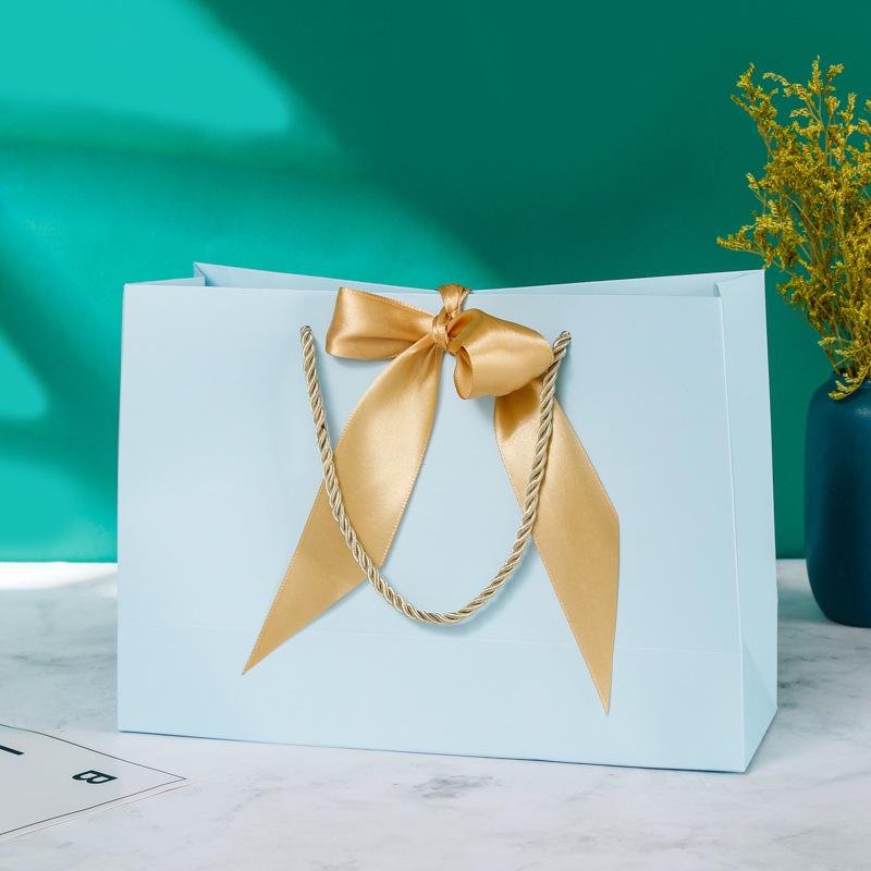 In-Stock White Cardboard Gift Bags with Bow Handle, Customizable Logo for Clothing Stores