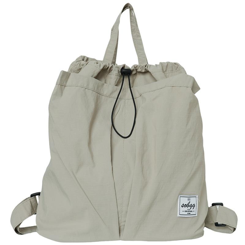 The new Hong Kong wind locomotive drawstring is simple andlarge-capacity leisure. Men and women have the same commuter backpack and student schoolbag.