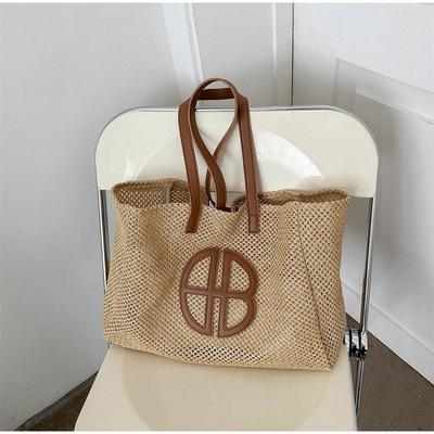 Sac fourre-tout en paille ajouré tricoté grande capacité sac à main à bandoulière fait main pour femme 2024 sac de plage décontracté de créateur style ethnique