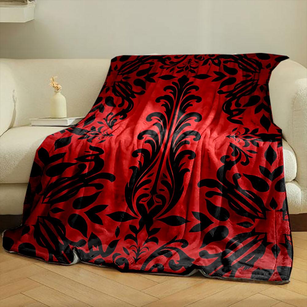 Kräftige schwarze Blumenmotive auf rotem Hintergrund mit symmetrischem Design. Decke für alle Jahreszeiten Mittagspause Überwurf Geschenk