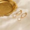 Natural Pearl Button-style Earrings with a Strong, Hollow Geometric Oval Design, Exuding an Elegant, Minimalist, and Versatile Chic Style