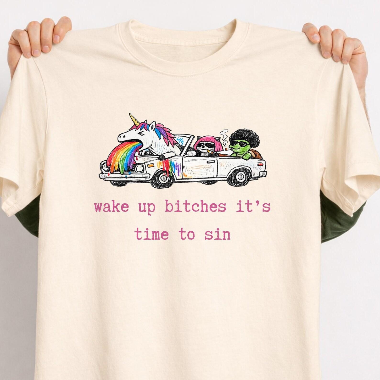 Stylish Wake Up Bitches It’s Time To Sin Shirt, Funny Unicorn Rainbow Vomit Tee, Raccoon Pink Hair Aesthetic, Weird Cute Graphic T-Shirt. L
