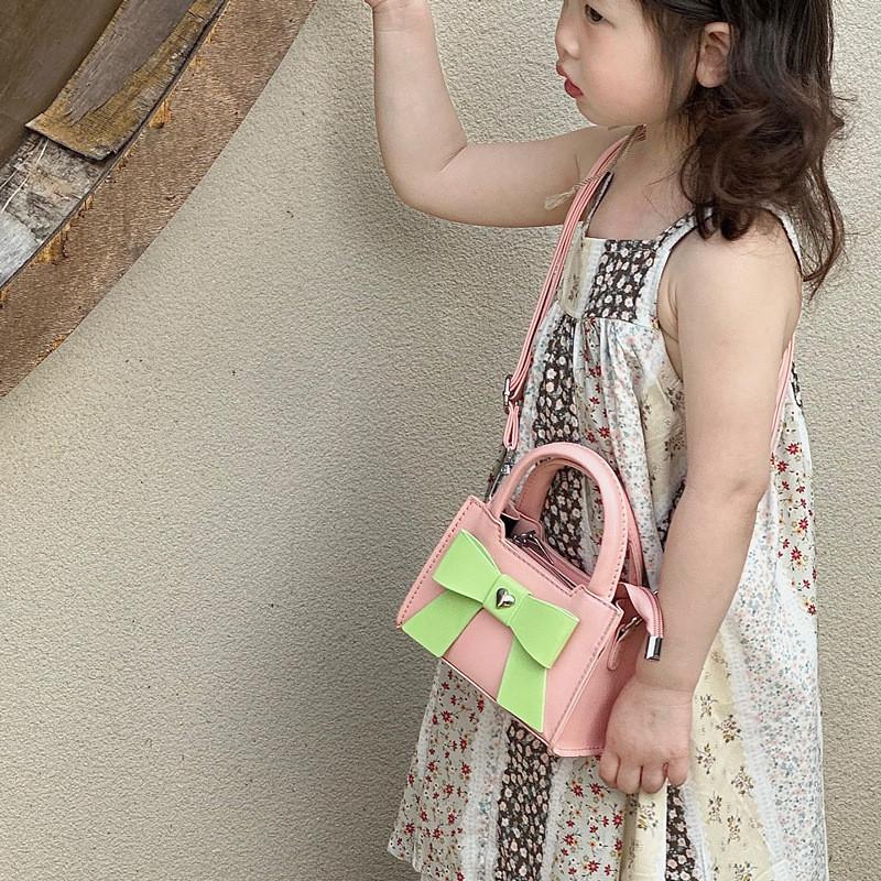 Stylish Korean Toddler Shoulder Bag For Kids Featuring Chic Color Block Design And Sweet Bow Detail