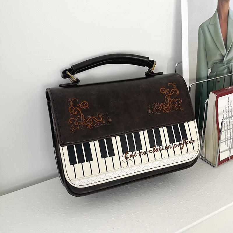 Bolso de mensajero de encaje de piano literario retro de alto valor, bolso de mano versátil, mochila simple, maletín, bolso de hombro