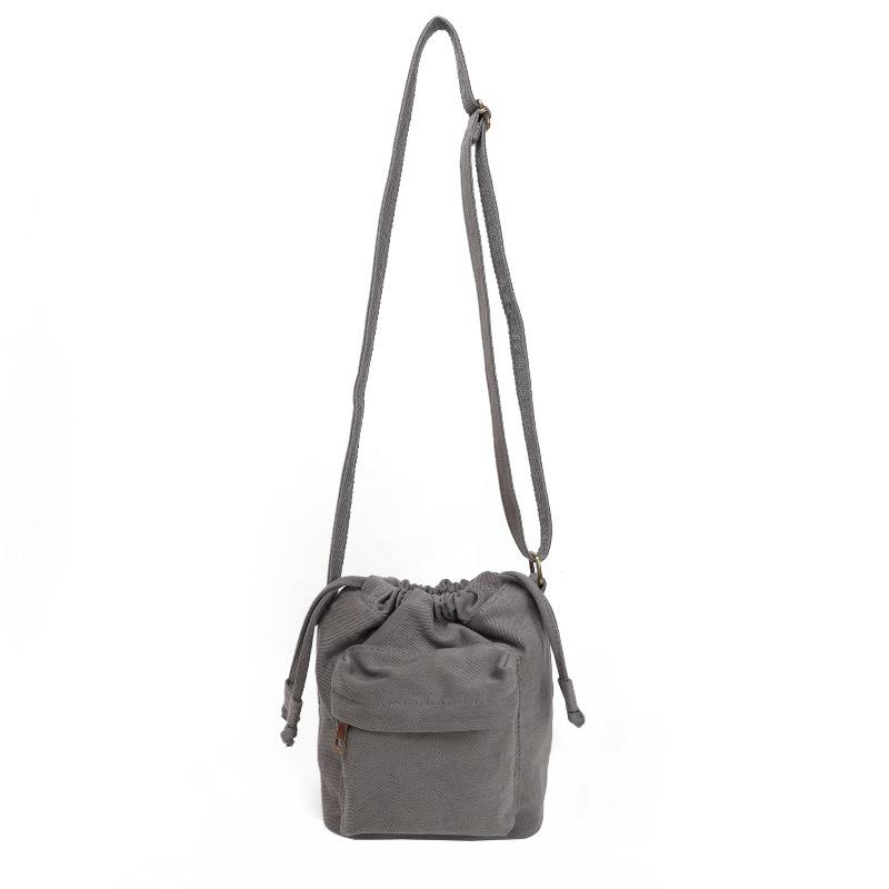 

Retro single shoulder canvas bag female crossbody solid color small bag with belt belt 2025 new bucket bag literary style серый