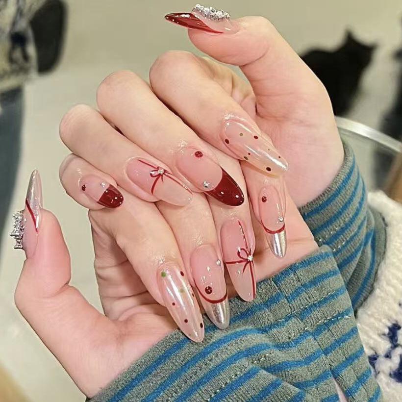 

New Year Red Almond Cat Eye Nails with Magic Mirror Finish and Crystal Stones