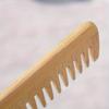 A Bamboo and Wood Hair Comb for Both Men and Women, Featuring A Wide-Toothed Design for Curling Hair and Grooming Beards
