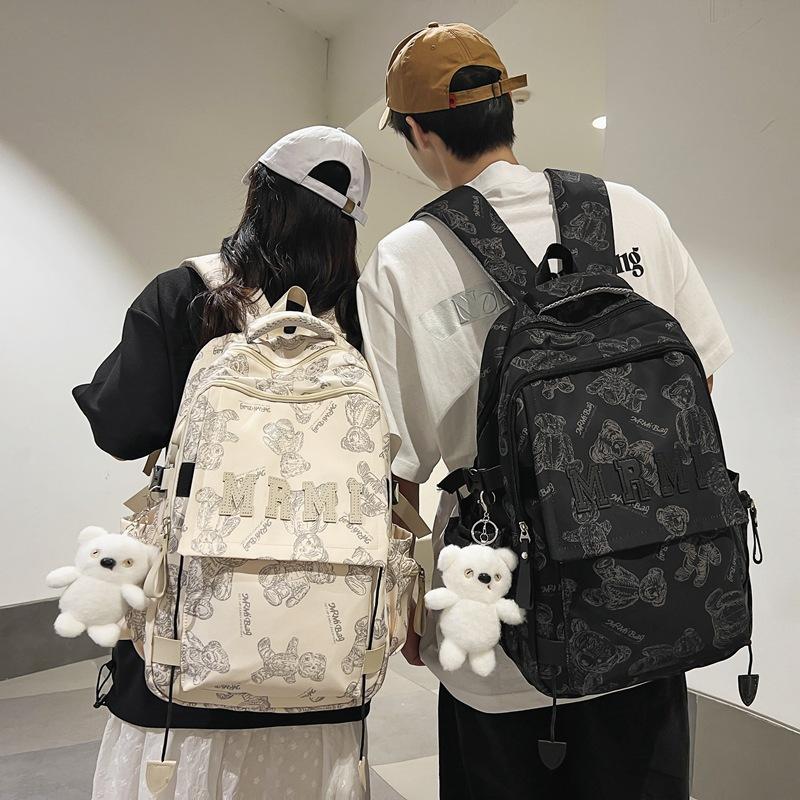 The new bear graffiti backpack has a large capacity of foreign style tide and a couple of middle and high school students have a class backpack tide.