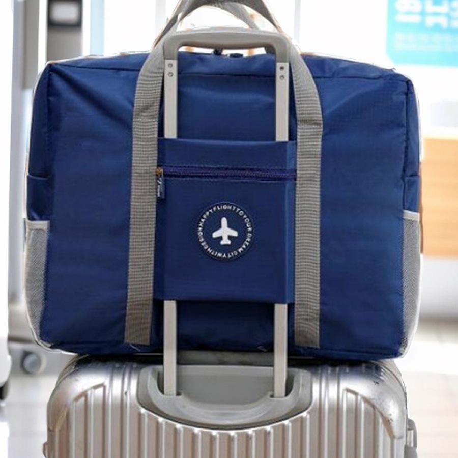 Compact travel bag: suitcase-compatible, hand-held, features an external pocket, handle slip-over design, with matching accessory bag.