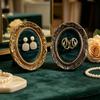 Ring Display Tray with Multiple Horizontal Slots, Ornate Oval Scrollwork Frame and Flat Base for Tabletop Presentation