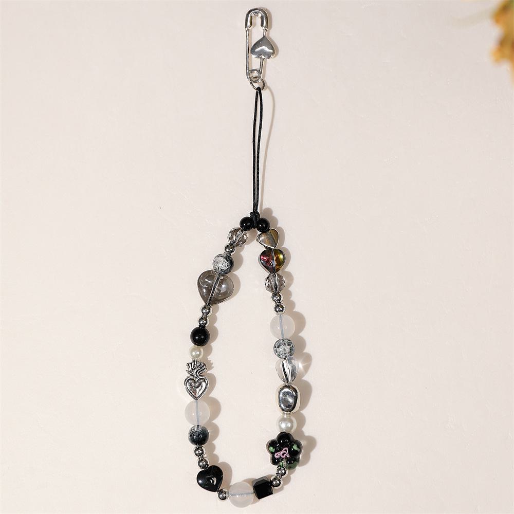 

Многоэлементный брелок для телефона в виде цветка с золотой глазурью, с чехлом для наушников и подвеской для камеры, защищающей от падения. чёрный