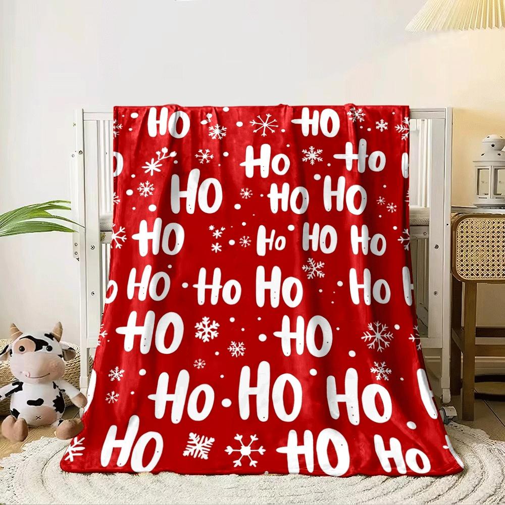 The pattern features Ho Ho text and snowflakes on a red background. for all seasons blanket lunch break throw gift 80cm x 120cm