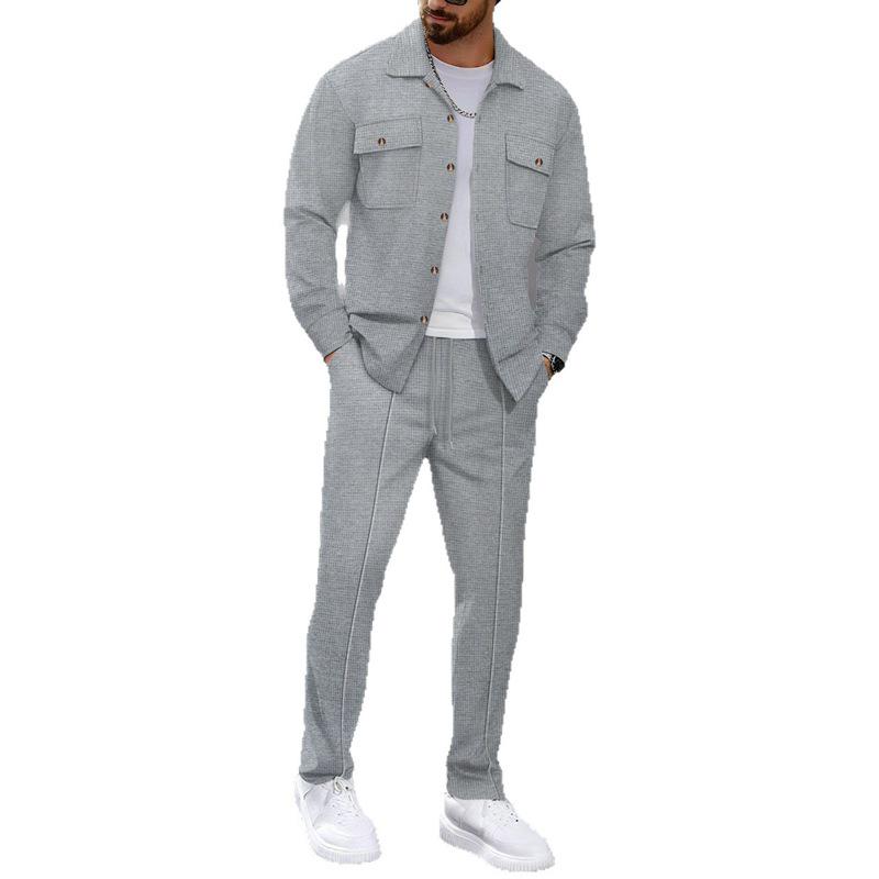 Completo casual da uomo autunnale europeo con giacca a maniche lunghe a nido d'ape e pantaloni