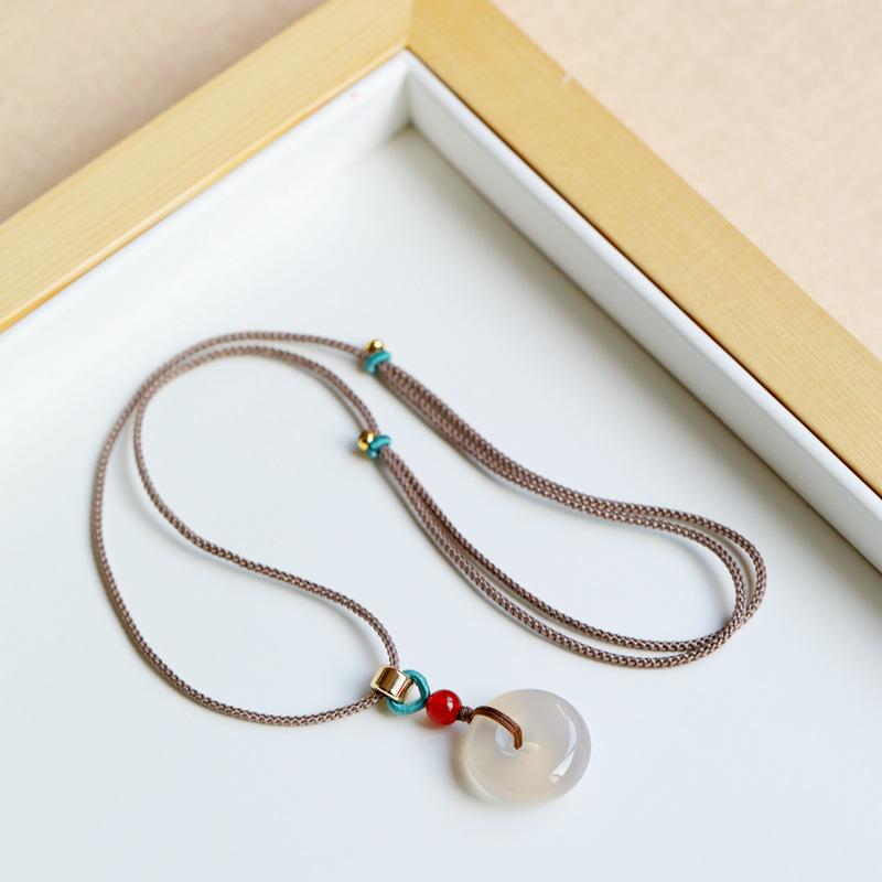 

Peace and Safety Ice Jade Chalcedony Crystal Peace Buckle Pendant Lucky Jade Pendant for Women and Babies Khaki-colored rope style