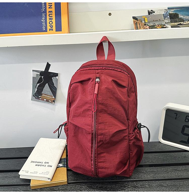 School bag Solid color outdoor mountaineering waterproof pleated backpack Lightweight leisure travel messenger bag Niche versatile simple breast bag