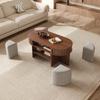 Oval storage coffee table with vertical fluted panelling, set with fabric stools, body made of particleboard+MDF, metal handles, with sliding doors