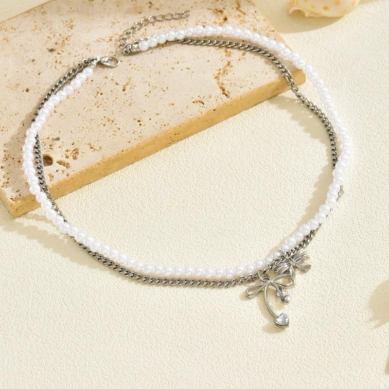Alloy hollow bow pendant stacked with simple temperament pearl necklace light luxury niche design