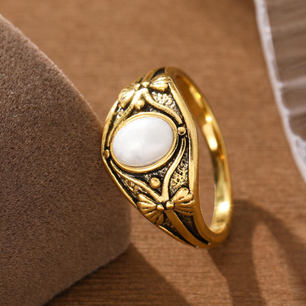 Retro luxurious engraved lotus-shaped copper ladies' ring, set with oval artificial gemstones, suitable for daily and date wear.
