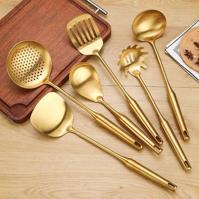Golden Stainless Steel Kitchen Tool Set: Spatula, Soup Ladle, Skimmer, and Large Slotted Spoon for Stir-fry Cooking.