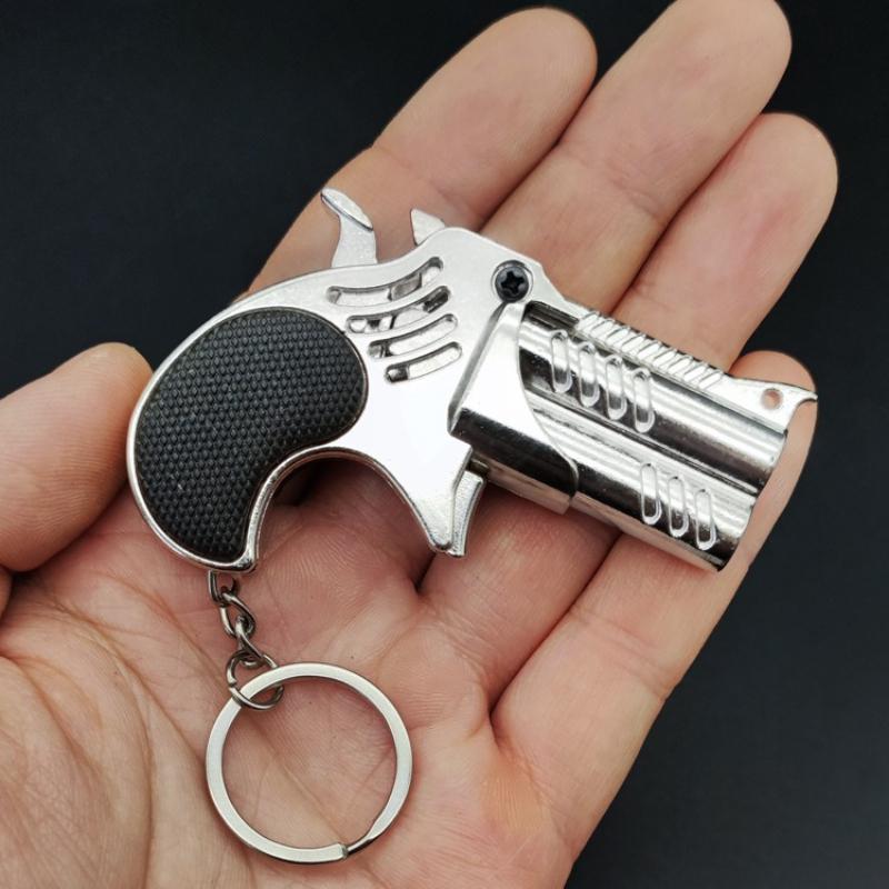 1 Pezzo Mini Portachiavi Metallo Elastico Giocattolo Pistola Gioco Pistola Lanciatore Pistola Simulazione per Adulti Giocattoli Regali Ciondolo