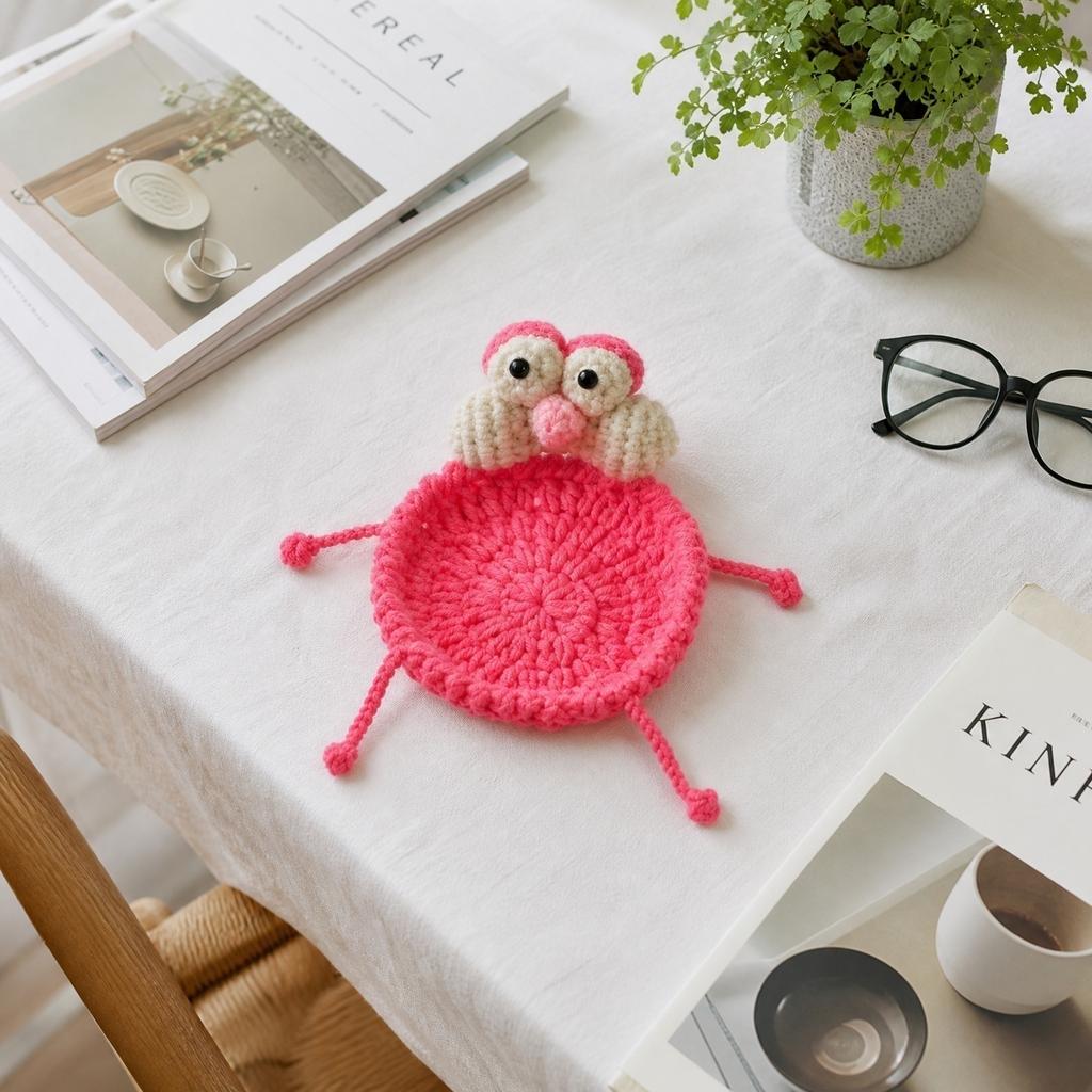 Handmade Crochet Cartoon Style Round Coaster with Four Extended Legs and Decorative Eyes and Nose Detail for Table Protection and Home Use