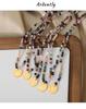 European-American Niche: Blue Spirit Grey Natural Stone Handmade Necklace with Starry Sky Glaze Angel Pendant in Gold-Plated Titanium Steel.