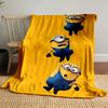 Three Minions in blue overalls hanging from each other on a yellow background. for all seasons blanket lunch break throw gift