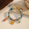 Europäisches und amerikanisches neues Meeresstil-farbiges Stoffarmband Muschel Kokospalmen-Anhänger leichter Luxus Damenschmuck Edelstahlschmuck