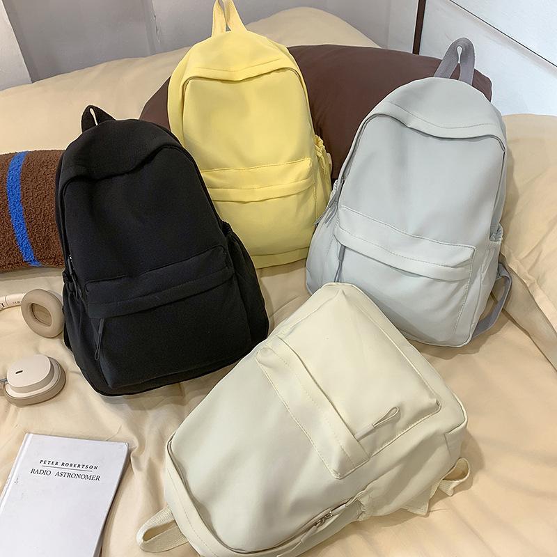 Solid color simple backpack girls' junior high school college student schoolbag large capacity niche versatile design large capacity backpack