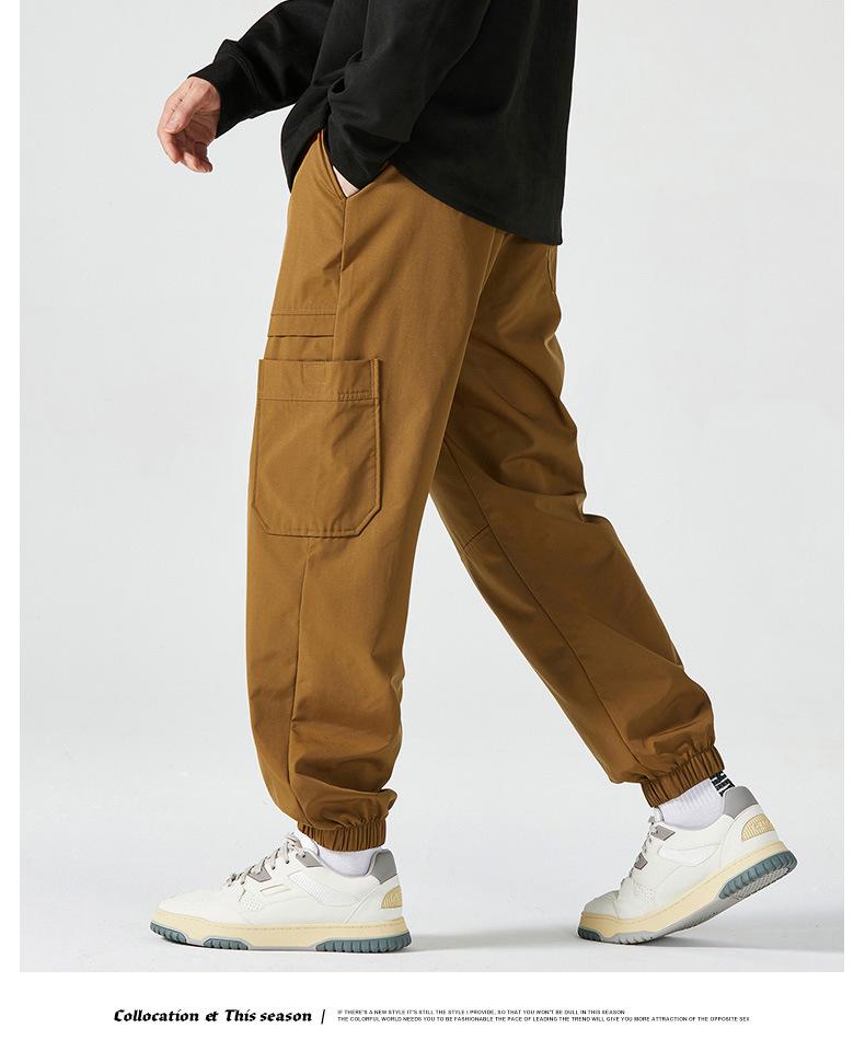 Men's American-Style Autumn Overalls: Fashionable, Casual, Versatile Nine-Point Pants with Loose Cuffs and Multi-Pocket Design.