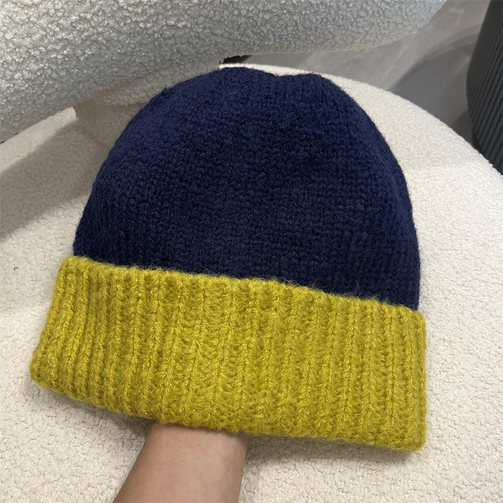 Simple two-color splicing wool hat women's autumn and winter warm niche versatile ear protection hat large version knitted pullover hat tide