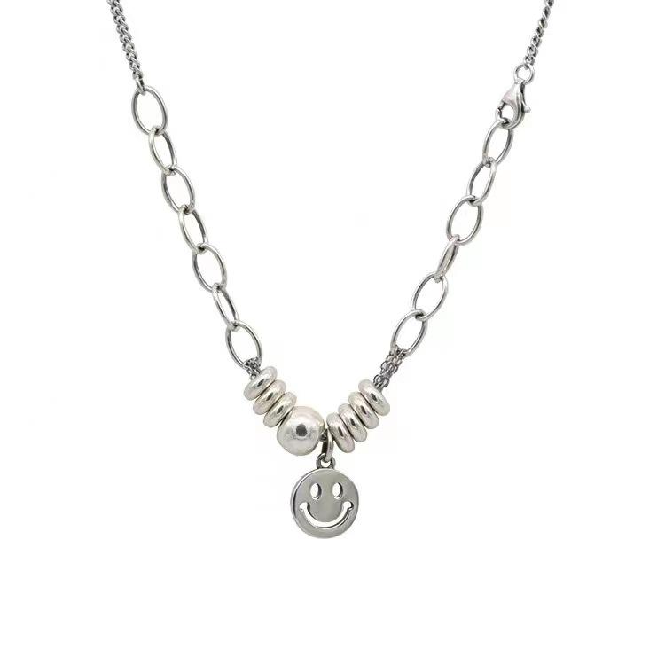 

New Japanese and Korean version jewelry hollow smiley face titanium steel necklace high-end hip-hop sweater does not fade pendant
