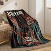 A skeletal figure intertwined with red veins, holding a human heart. for all seasons blanket lunch break throw gift