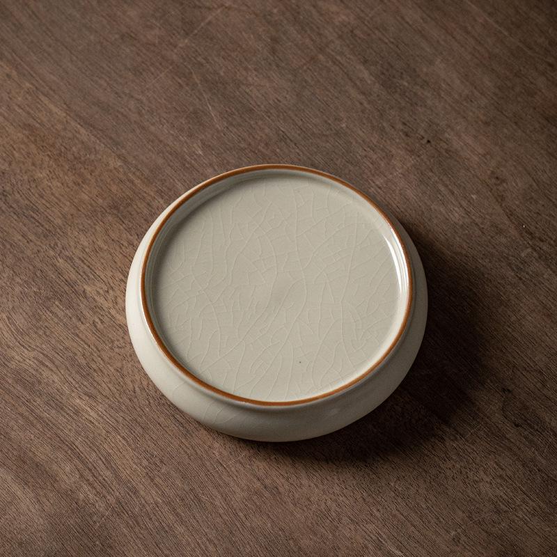 Ceramic Tea Set Coaster: Anti-Scald Round Insulation Mat with Mountain and Water Design.