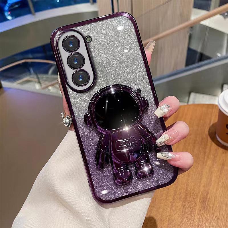 Astronaut Stand Suitable for Samsung S24ultra Mobile Phone Case S23Plus Gradient Flash Powder S22 Astronaut
