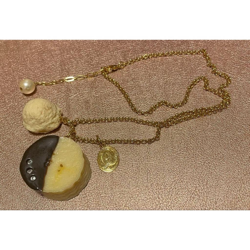 Used Q-POt banana chocolate necklace